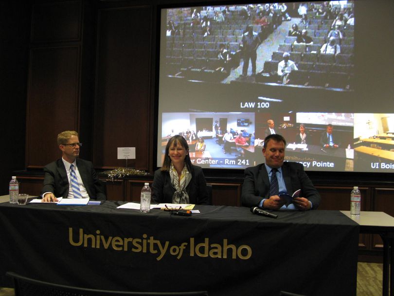 Attorneys Craig Durham, left, and Deborah Ferguson, center, who represent the four Idaho couples who successfully sued to overturn Idaho’s ban on same-sex marriage in federal court; and at right, Tom Perry, attorney for Gov. Butch Otter, who is thumbing through a pocket version of the U.S. Constitution, an item that’s been provided to all the attendees in Boise; participate in a Constitution Day event sponsored by the University of Idaho on Wednesday. (Betsy Russell)