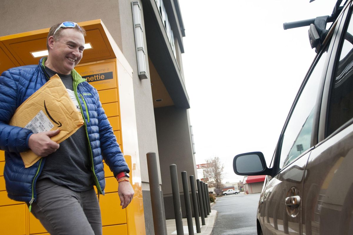 Brian Comstock, of Mead, gets a package from an Amazon Locker at Huppin’s  on Wednesday, Nov. 28, 2018, in Spokane. Customers can ship packages there instead of getting them delivered to their homes. (Kathy Plonka / The Spokesman-Review)