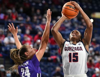 Gonzaga Bulldogs forward Yvonne Ejim (15) shoots against Portland Pilots guard Maisie Burnham (24) during the first half of a college basketball game on Thursday, Jan 20, 2022, at McCarthey Athletic Center in Spokane, Wash.  (Tyler Tjomsland/THE SPOKESMAN-REVIEW)