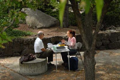 
Attorney Terry Sawyer listens to Virginia Graham talk about her legal issues during a free advice session at Riverfront Park in Spokane on Saturday. 
 (Brian Plonka / The Spokesman-Review)