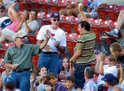 At the Spokane Indians Businessperson's Special baseball game, Brett Martin holds up the foul ball he caught during the fourth inning at Avista Stadium on Wednesday afternoon.
(Colin Mulvany / The Spokesman-Review)