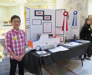 Dylan Prabowo, a 5th grader at Hemingway Elementary School in Sun Valley, shows off his idea for a car with external airbags, to reduce damage and injuries in car crashes. He was one of 20 young winners in the "Invent Idaho" competition who demonstrated their invention ideas in the Capitol on Monday. (Betsy Z. Russell)