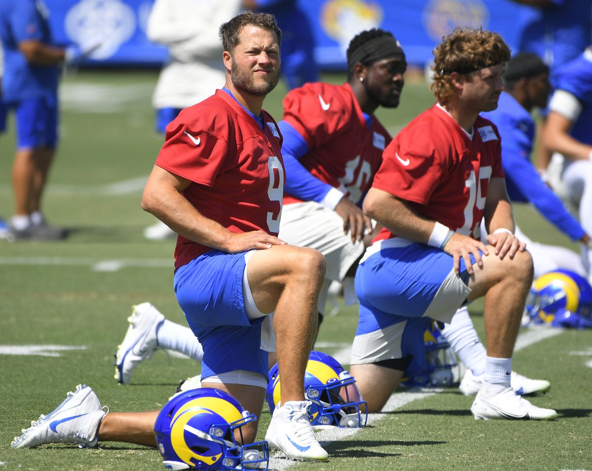 Los Angeles Rams quarterback Matthew Stafford, left, stretches during training camp on Aug. 6 in Irvine, Calif.  (Johm McCoy)