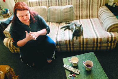 
Desiree Rounds contemplates the future with her fiancé and  cats, after she was informed that tenants of the New Madison Apartments would be evicted in July.  
 (Photos by Brian Plonka / The Spokesman-Review)