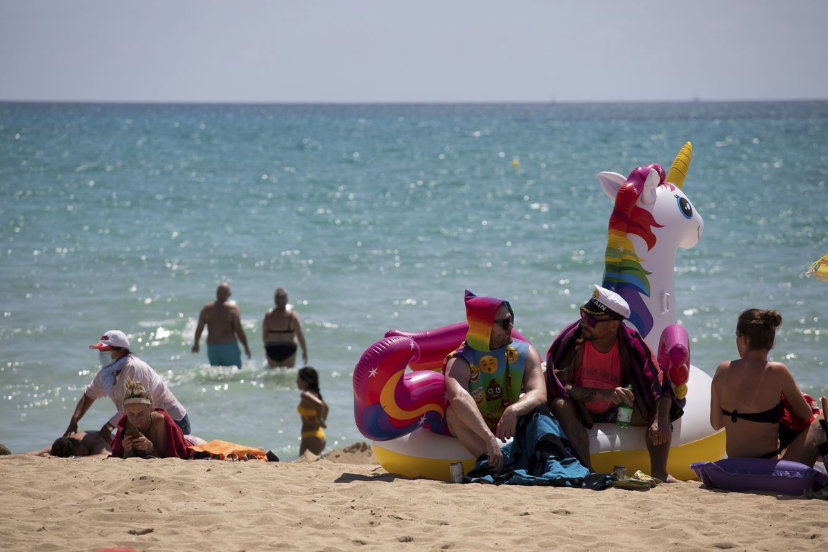 Tourists sunbathe on the beach at the Spanish Balearic Island of Mallorca, Spain, Monday.  (Francisco Ubilla)