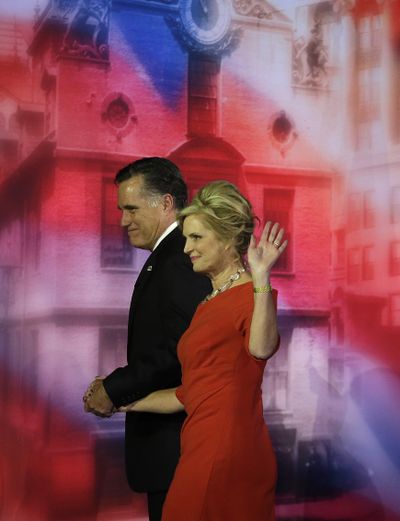 Republican presidential candidate and former Massachusetts Gov. Mitt Romney and his wife Ann walk off the stage after Romney conceded the race Wednesday in Boston. (Associated Press)