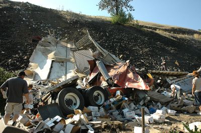 Kendrick residents salvage frozen seafood from the wreckage of a tractor-trailer that plummeted off  state Highway 99 on Sunday.  (Associated Press / The Spokesman-Review)