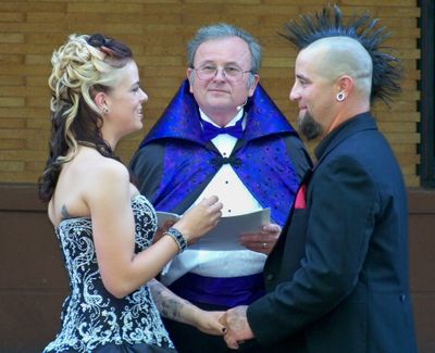 Ralph Fishburn of Ralph’s Regal Weddings officiates the nuptials of Carrie Olsen and Cory Munson on Aug. 6 at the Patsy Clark Mansion.