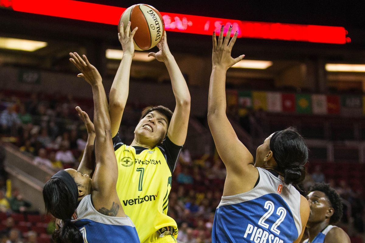 Seattle Storm’s Ramu Tokashiki tries to muscle her way into the lane to shootver Minnesota’s Jia Perkins (7) and Pienette Pierson (22) in the first half of a WNBA basketball game Saturday, June 3, 2017, in Seattle. (Dean Rutz / Seattle Times via AP)