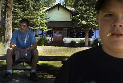 
Richard Cassidy, 13, left, and Josh Zaagsma, 13, both of Spokane, rest in front of Finch Lodge on Tuesday at the Cowles Scout Reservation on Diamond Lake. 
 (Photos by Jed Conklin / The Spokesman-Review)