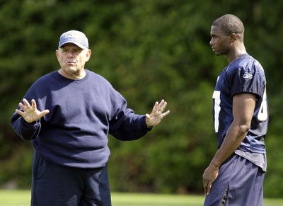 Wide receiver coach Keith Gilbertson, left, talks with Ben Obomanu at the first day of the team’s training camp. (Associated Press / The Spokesman-Review)