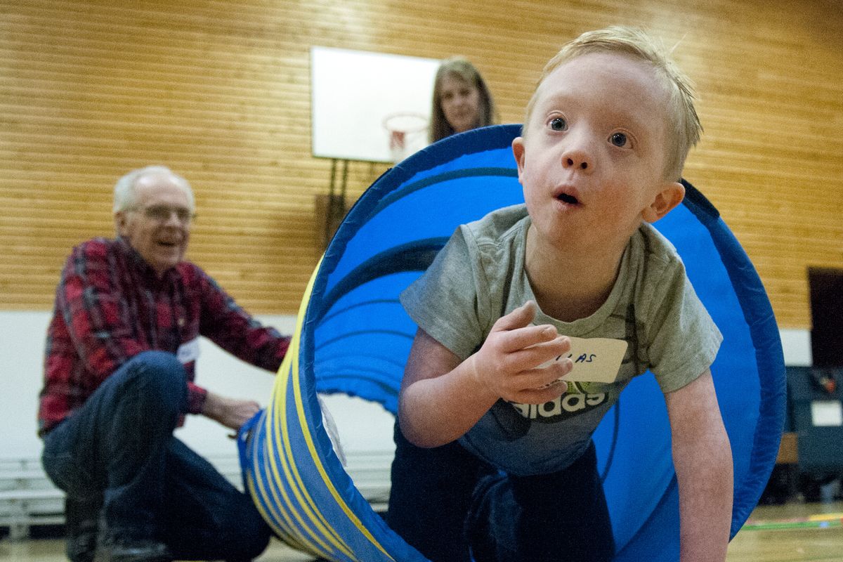Silas Todhunter, 6, emerges from a tunnel that was part of an obstacle course Saturday at the West Central Community Center.