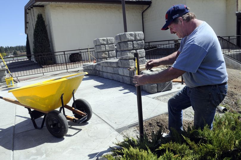 Keith Arp levels a fence post at the newly constructed Veterans Memorial in front of Valley Fourth Memorial Church. When completed, the memorial will be available 24/7 for community members to pray and meditate for members of the military. (J. Bart Rayniak)