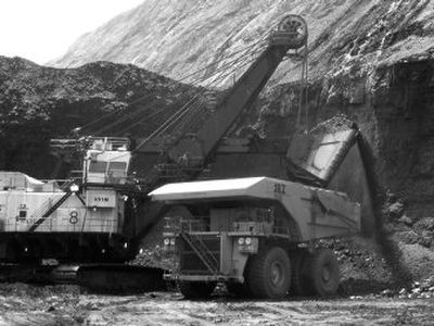 
A shovel prepares to dump a load of coal into a 320-ton truck at the Black Thunder Mine in Wright, Wyo. The coal mine, the nation's largest, produces more than 90 million tons of coal a year. 
 (Associated Press / The Spokesman-Review)