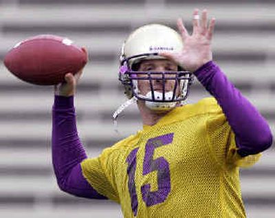 Washington quarterback Casey Paus throws on the first day of spring drills last Thursday.
(Associated Press / The Spokesman-Review)