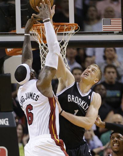 Brooklyn forward Mason Plumlee blocks a shot by Miami’s LeBron James in the final seconds to preserve an 88-87 win over the Heat. (Associated Press)