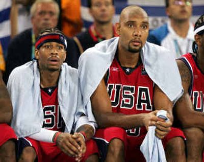 
Allen Iverson, left, and Tim Duncan of the U.S. watch their team fall behind 49-27 after the first half and lose 92-73 during a men's basketball tournament preliminary match against Puerto Rico.
 (Associated Press / The Spokesman-Review)