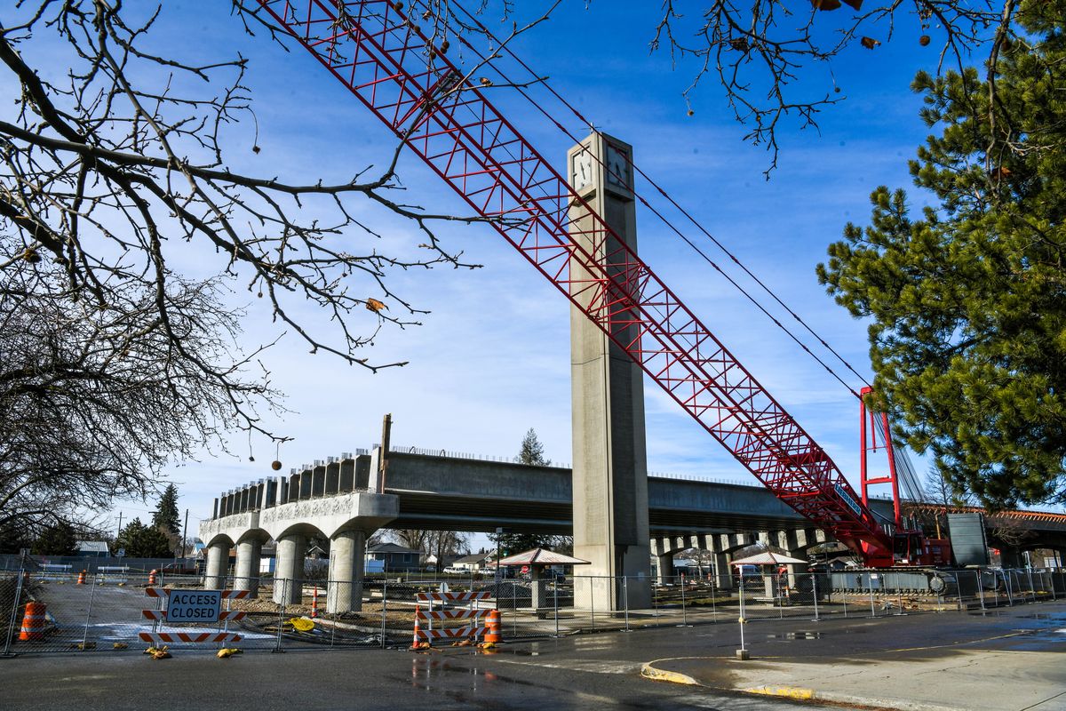 The Spokane Community College clock tower stands in the shadow of construction for the North Spokane Corridor freeway project  (Dan Pelle/THE SPOKESMAN-REVIEW)