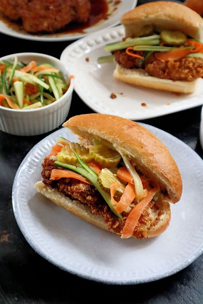 An air-fried chicken sandwich glazed with a glossy sauce made from honey, dark soy and garlic, and topped with cucumber salad.  (Pittsburgh Post-Gazette)