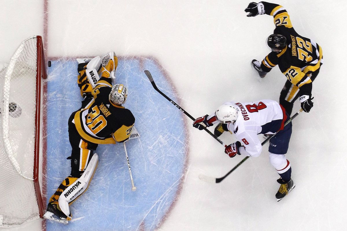 Washington Capitals’ Alex Ovechkin (8) puts the go-ahead goal behind Pittsburgh Penguins goaltender Matt Murray (30) with Patric Hornqvist (72) defending during the third period in Game 3 of an NHL second-round hockey playoff series in Pittsburgh, Tuesday, May 1, 2018. The Capitals won 4-3. (Gene J. Puskar / Associated Press)