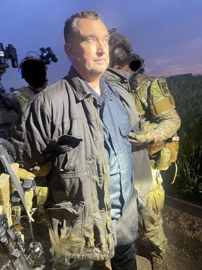 Suspected shooter Vance Boelter being taken into custody on Sunday near Green Isle, Minn., following a manhunt by law enforcement officers. (Courtesy of Ramsey County (Minnesota) Sheriff's Office)