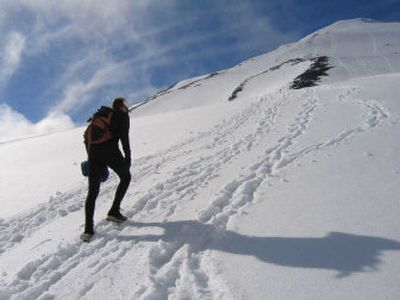 
Buzz Burrell ascends Mount Adams during the effort to set a three-peak climbing speed record.
 (Photo by Bridget Fees/Uncage the Soul Productions / The Spokesman-Review)