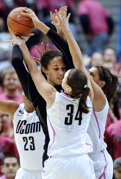 Connecticut's Kelly Faris (34), Stefanie Dolson, right, and Kaleena Mosqueda-Lewis (23) pressure Baylor's Brittney Griner, center, who tallied her 3,000th point. (Associated Press)