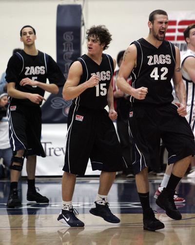 Gonzaga forward Josh Heytvelt (42), guard Matt Bouldin (15) and forward Austin Daye leave the court in triumph.   (Associated Press / The Spokesman-Review)