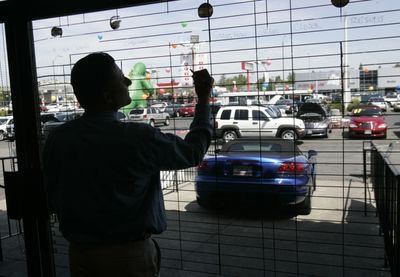 Salesman Ed Gross writes up sales figures on a window at a Chrysler dealership in San Jose, Calif., Thursday. Chrysler will file for bankruptcy after talks with a small group of creditors crumbled just a day before a government deadline for the automaker to come up with a restructuring plan. (Associated Press / The Spokesman-Review)