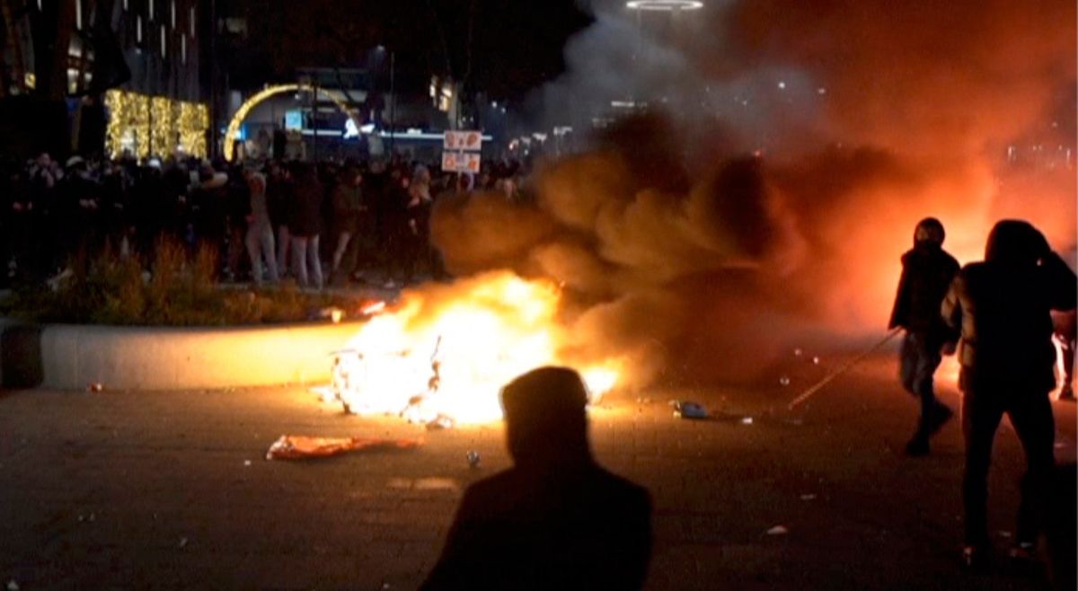 In this image taken from video, demonstrators protest against government restrictions due to the coronavirus pandemic, Friday, Nov. 19, 2021, in Rotterdam, Netherlands. Police fired warning shots, injuring an unknown number of people, as riots broke out Friday night in downtown Rotterdam at a demonstration against plans by the government to restrict access for unvaccinated people to some venues.  (TEL)