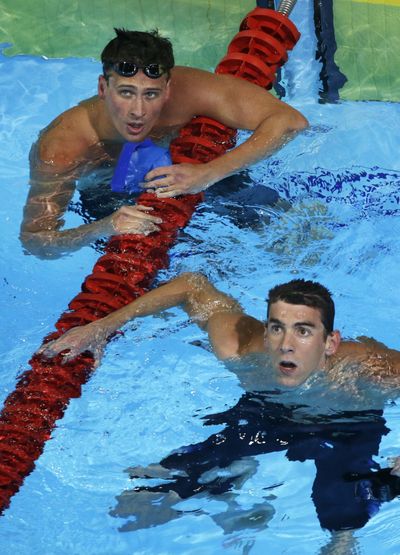 Phelps and Lochte, left, check the clock after 200-meter freestyle. (Associated Press)