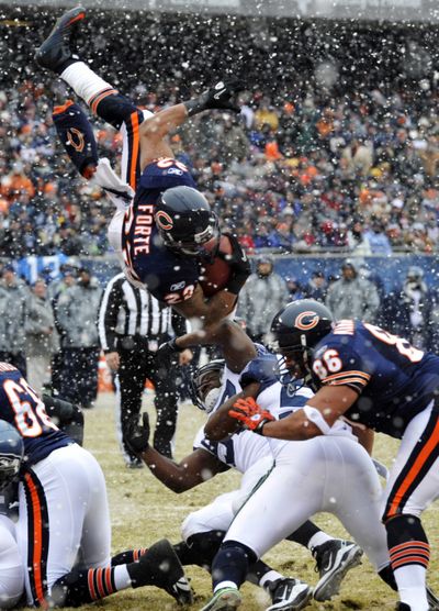 Bears running back Matt Forte dives for the goal line on a snowy day in Chicago in a playoff win over the Seahawks in January. (Associated Press)