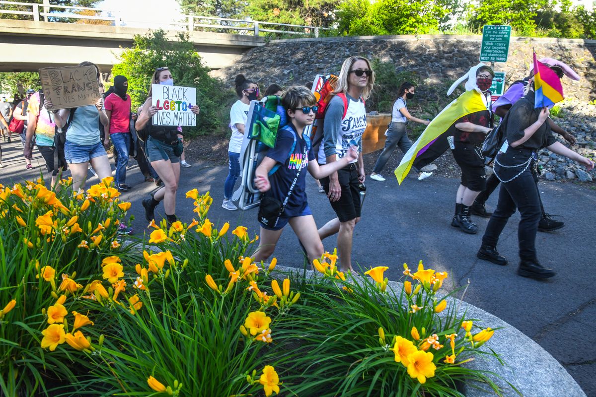 "WE ARE ONE" march participants walk along the Centennial Trail in Riverfront Park, Saturday, June 27, 2020, in Spokane.  (DAN PELLE/THE SPOKESMAN-REVIEW)