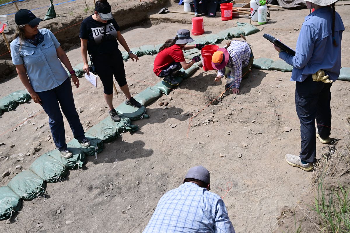 Dr. Shannon Tushingham, left, watches Monday as Washington State University students work at an archaeological excavation of prehistoric earth ovens near Newport, Wash.  (Tyler Tjomsland/The Spokesman-Review)