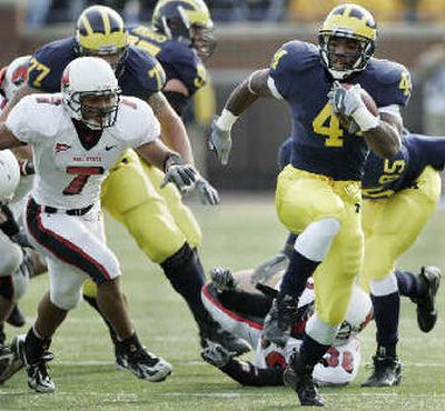 
Michigan running back Brandon Minor (4) breaks away from Ball State cornerback Erik Keys (7). 
 (Associated Press / The Spokesman-Review)