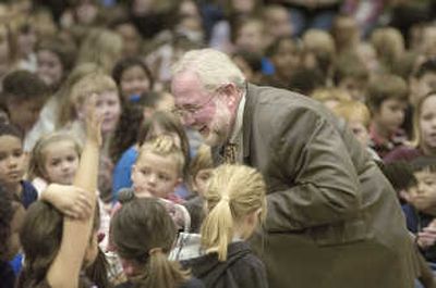 
Spokane Postmaster Edward Schierberl leans  into a group of Grant Elementary students to talk about the new stamp (below) that he unveiled at the school last Friday. 
 (Christopher Anderson / The Spokesman-Review)