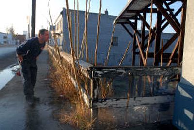 
Firefighter Mike Baechler checks out a broken water pipe on East Sprague in Spokane on Thursday. 
 (Jesse Tinsley / The Spokesman-Review)