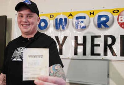 
Eric Kyle hold his winning Powerball ticket during a news conference Thursday in Boise. The 22-year-old manager of a local cafe won a $18.7 million jackpot.
 (Associated Press / The Spokesman-Review)
