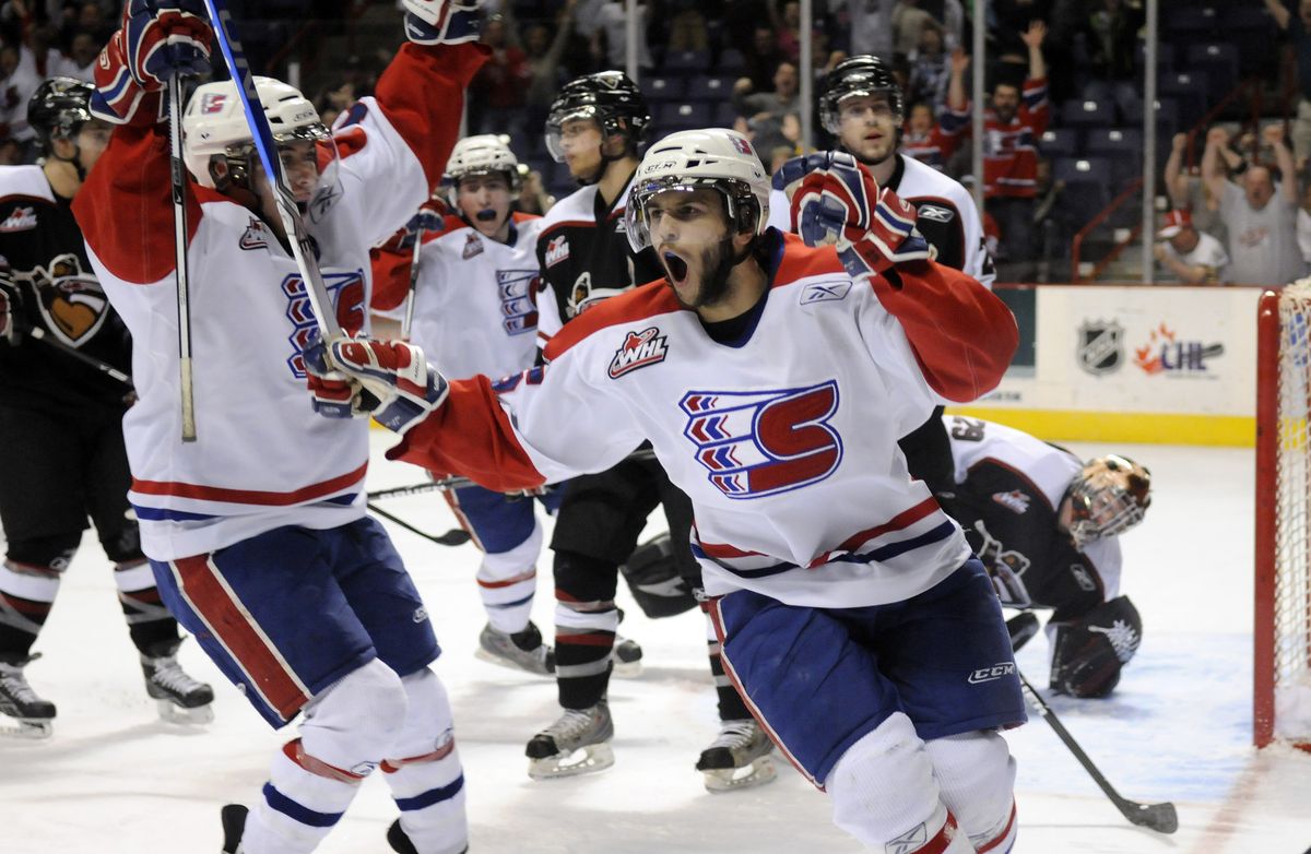 Spokane’s Levko Koper, right, celebrates opening the scoring with a power-play goal 8 minutes, 20 seconds into the first period. (Colin Mulvany / The Spokesman-Review)