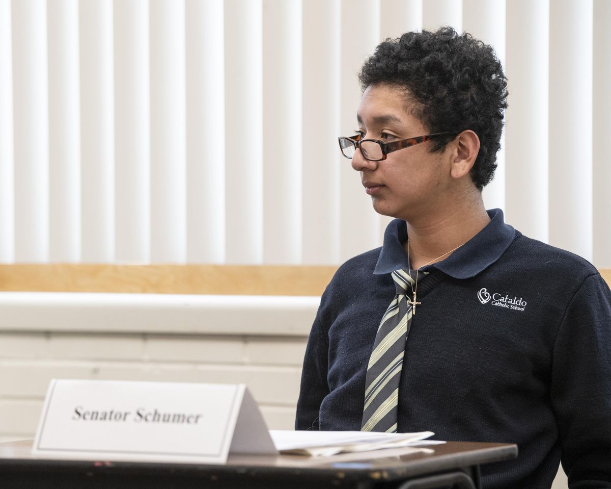Eighth-grader Daniel Harrington added a clip-on tie and perches reading glasses on his nose to play Sen. Charles Schumer (D-NY) during a mock impeachment trial in his class at Cataldo Catholic School in Spokane Wednesday, Feb. 5, 2020. The 22 students in the history class took the names of actual U.S. senators, caucused by party then voted on the president’s removal from office. Since the students were divided in similar proportions to the actual U.S. Senate, the kids’ vote acquitted the president. (Jesse Tinsley / The Spokesman-Review)