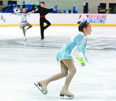 
Emily Korotish finds a teddy bear as she sweeps between Novice Dance performances at the Spokane Convention Center during the U.S. Figure Skating Championships on Sunday. 
 (Dan Pelle / The Spokesman-Review)