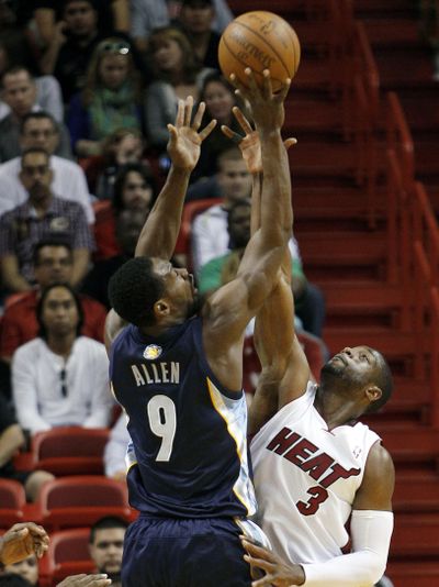 Miami Heat’s Dwayne Wade had four of his five blocks in the first minute of the game against Memphis. (Associated Press)