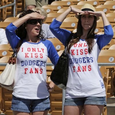 Two Los Angeles Dodgers fans watch batting practice before the Dodgers play the Seattle Mariners in a spring training baseball game Saturday, March 27, 2010 in Glendale, Ariz. (Tony Dejak / Associated Press)