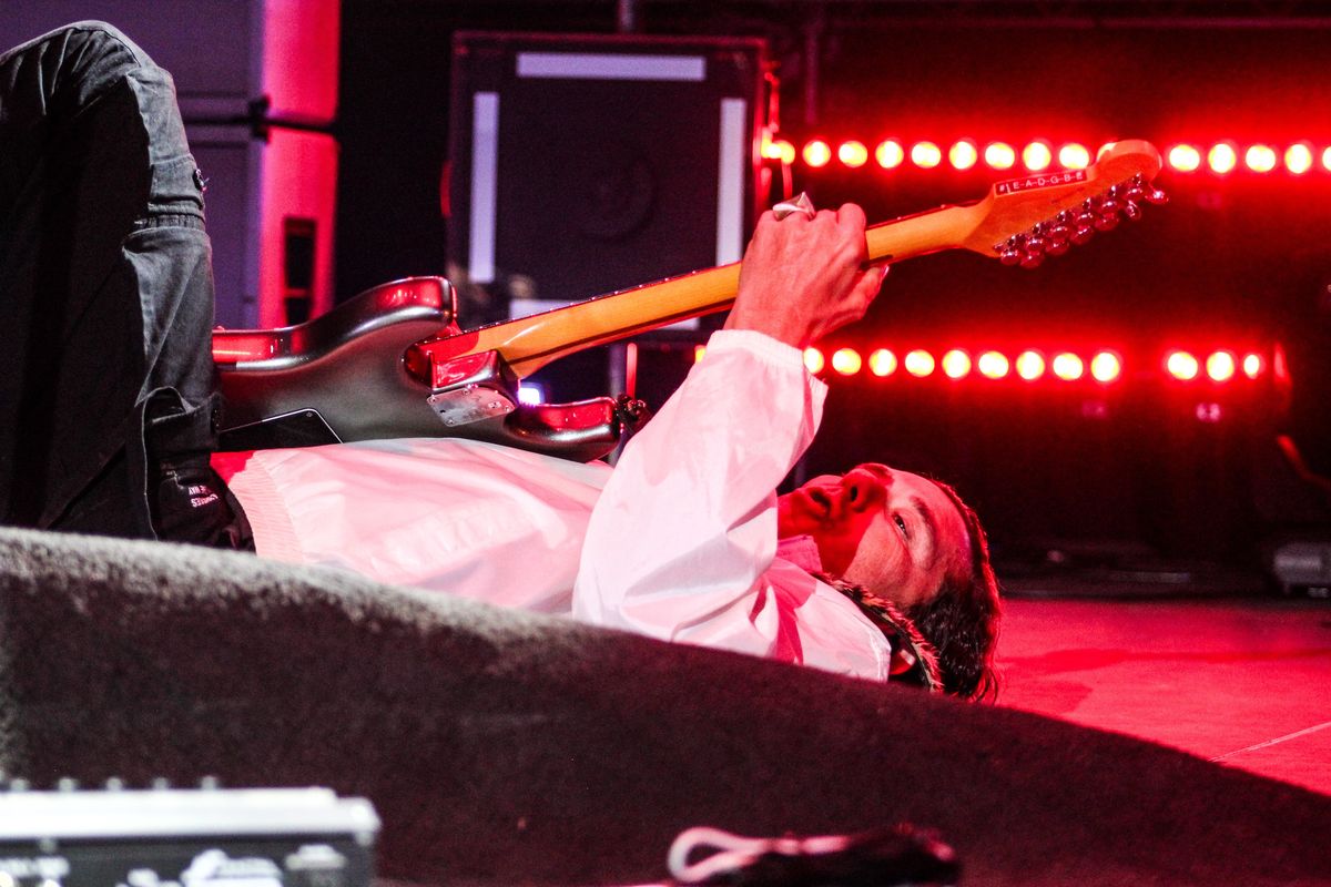 Frontman Gavin Rossdale plays guitar on his back Saturday during Bush