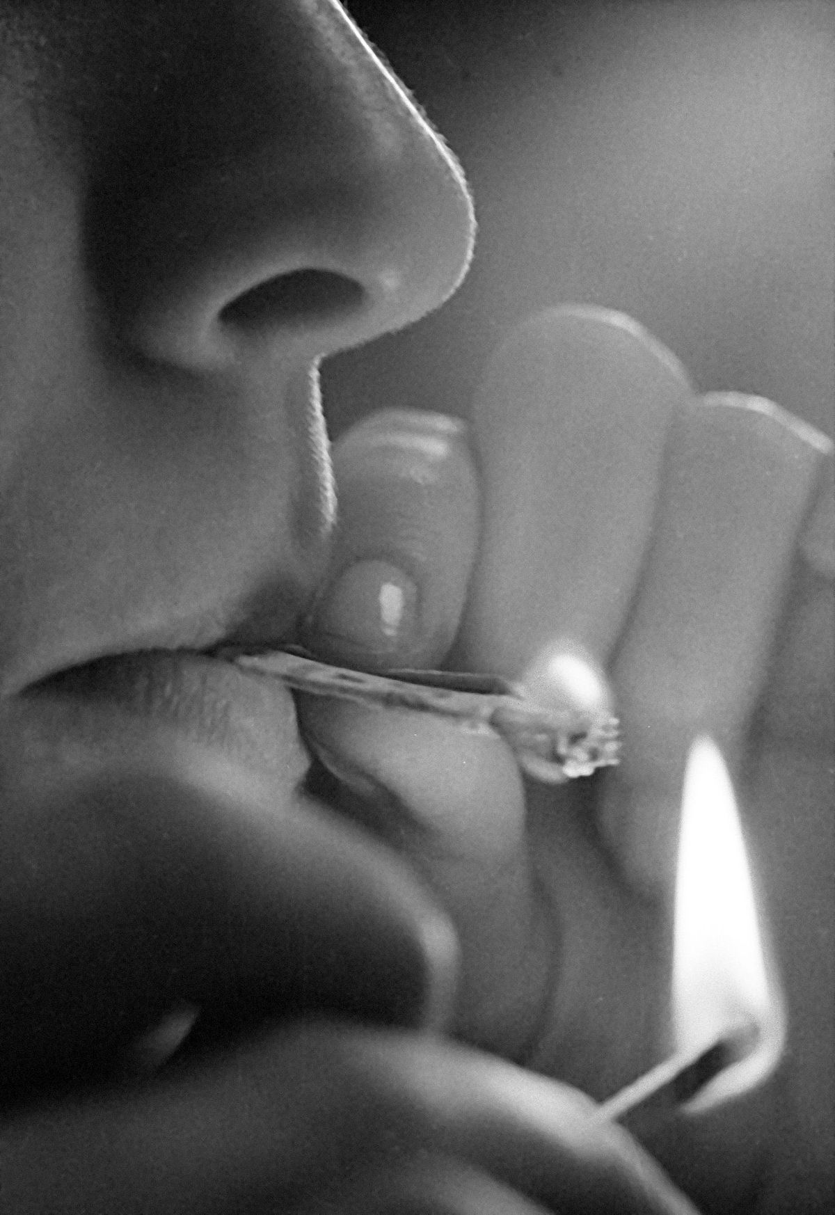 FILE - In this Jan. 24, 1972, file photo, a teenager relights the remainder of a marijuana joint. In 1972 a commission appointed by President Richard Nixon to study marijuana said it should be decriminalized and regulated. Nixon rejected that, but a dozen states in the 1970s went on to eliminate jail time as a punishment for pot arrests. On the occasion of  �Legalization Day,� Thursday, Dec. 6, 2012, when Washington�s new law takes effect, AP takes a look back at the cultural and legal status of the �evil weed� in American history. (Jerry Mosey / Associated Press)