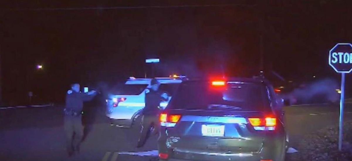 U.S. Park Police officer Lucas Vinyard, left, is shown firing his first shot as fellow Park Police officer Alejandro Amaya aims his handgun at Bijan Ghaisar