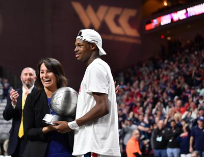 Gonzaga’s Joel Ayayi receives the WCC Tournament MVP trophy from conference commissioner Gloria Nevarez following the Zags’ win over Saint Mary’s in the title game. (Tyler Tjomsland / The Spokesman-Review)