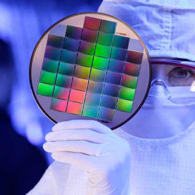 
In this undated photo released by Eastman Kodak Co., an unidentified Kodak technician shows image sensors embedded on a silicon wafer at Eastman Kodak Inc., in Rochester, N.Y. Kodak is announcing new sensor technology that will provide an increase in the sensitivity to light.Associated Press
 (Associated Press / The Spokesman-Review)
