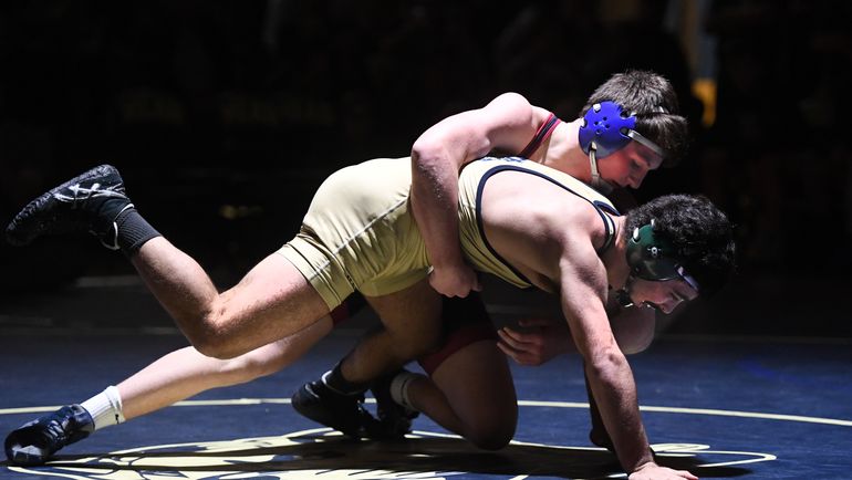 Mt. Spokane's Carter Meithe (top) battles Mead's Josh Hackworth in the 160-pound weight class at Mead High School on Jan. 25, 2019. On Friday, organizers of the annual Tri-State wrestling meet at North Idaho College cancelled the 2020 event due to COVID-19 concerns. (Colin Mulvany / The Spokesman-Review)