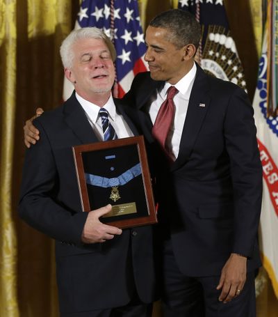 President Barack Obama stands with Ray Kapaun, nephew of U.S. Army Chaplain Emil J. Kapaun, as he awards the Medal of Honor posthumously to Chaplain Kapaun in the White House on Thursday. (Associated Press)